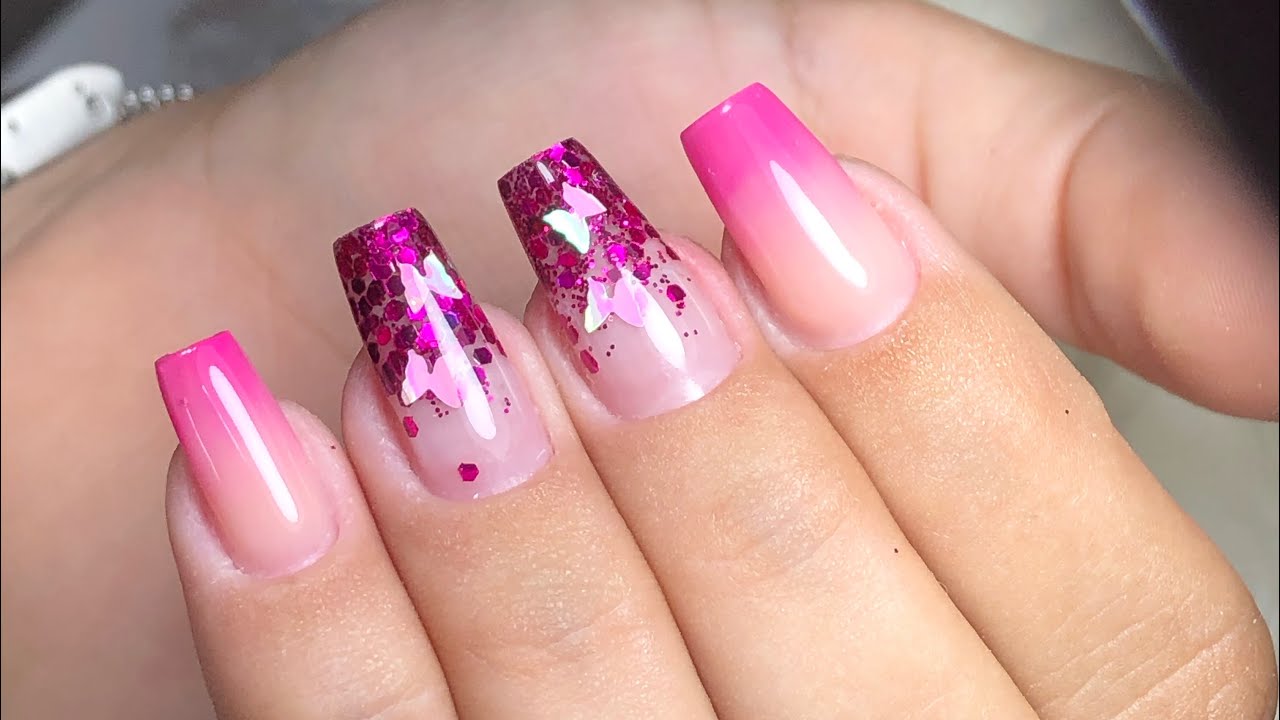 unha em fibra de vidro com decoração rosa, glitter e borboletas